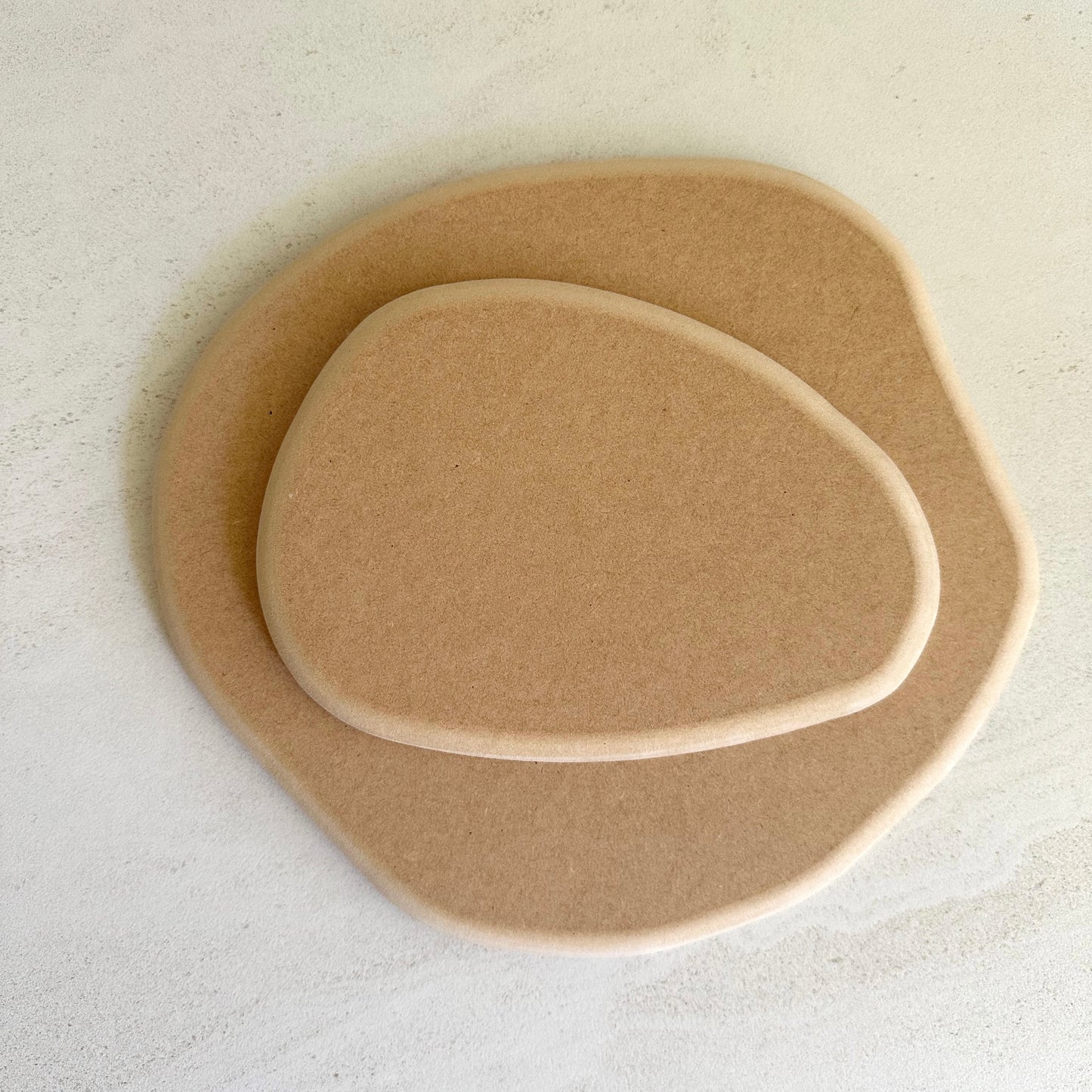 Irregular round pottery form/drape mould with soft roundover edge.