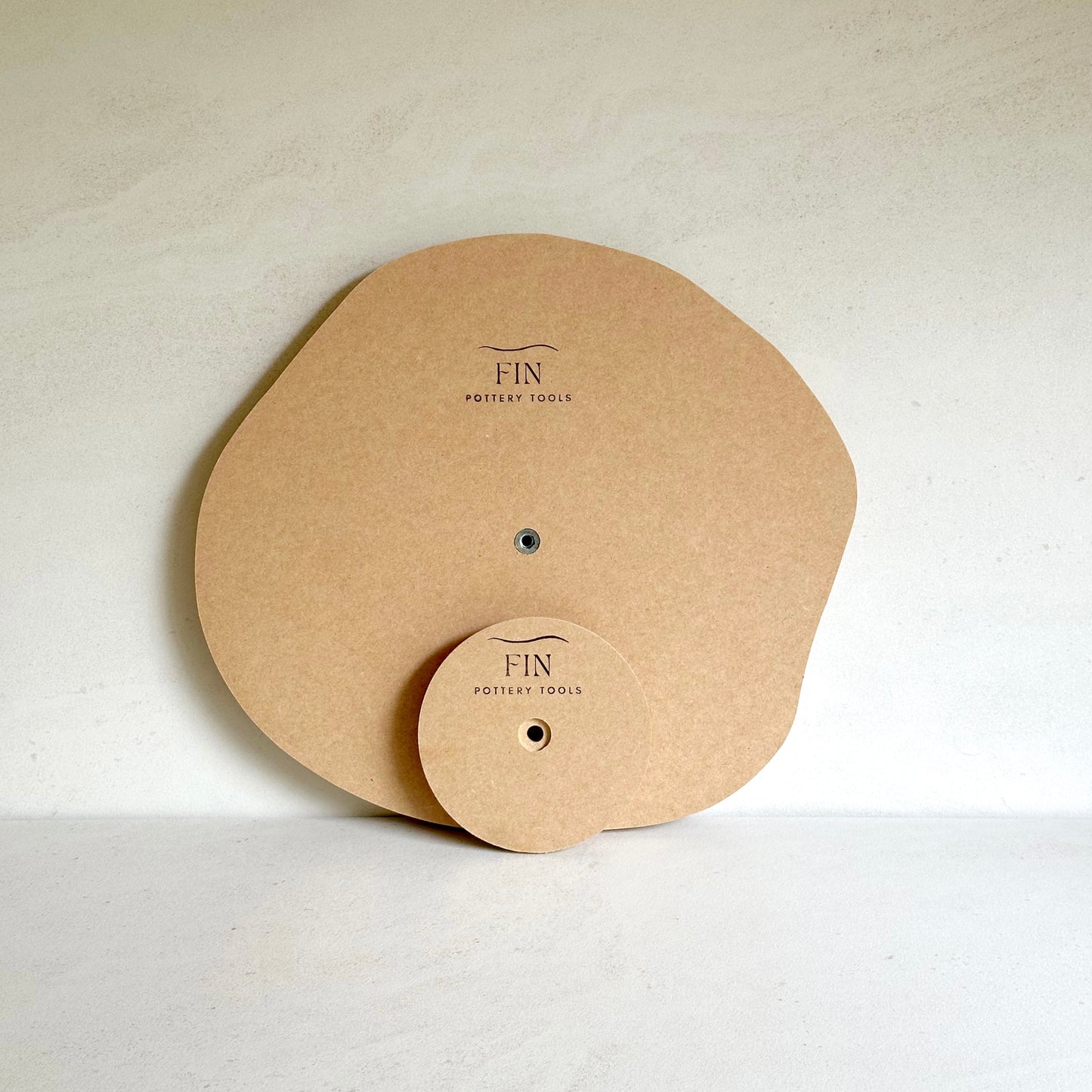 Irregular round pottery form/drape mould with soft roundover edge.