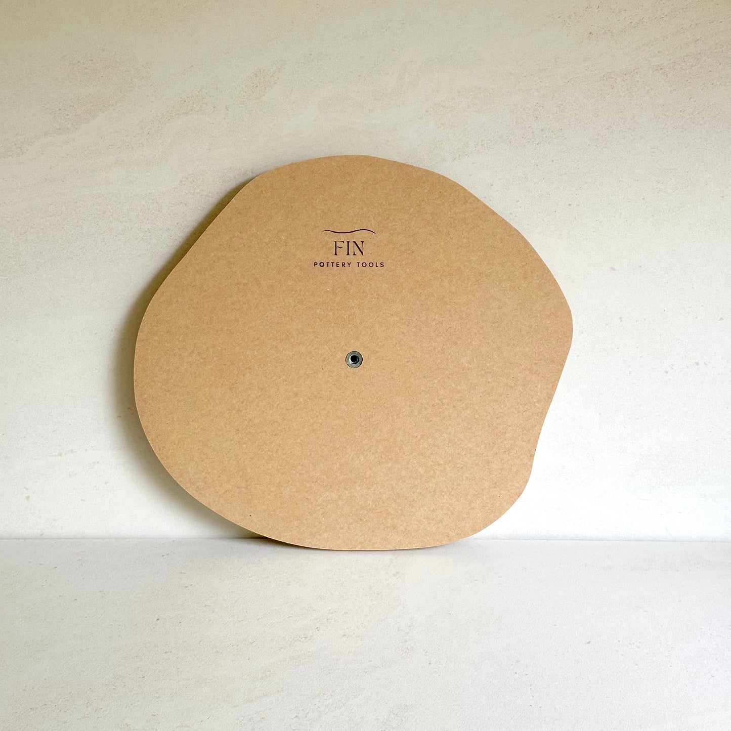 Irregular round pottery form/drape mould with soft roundover edge.