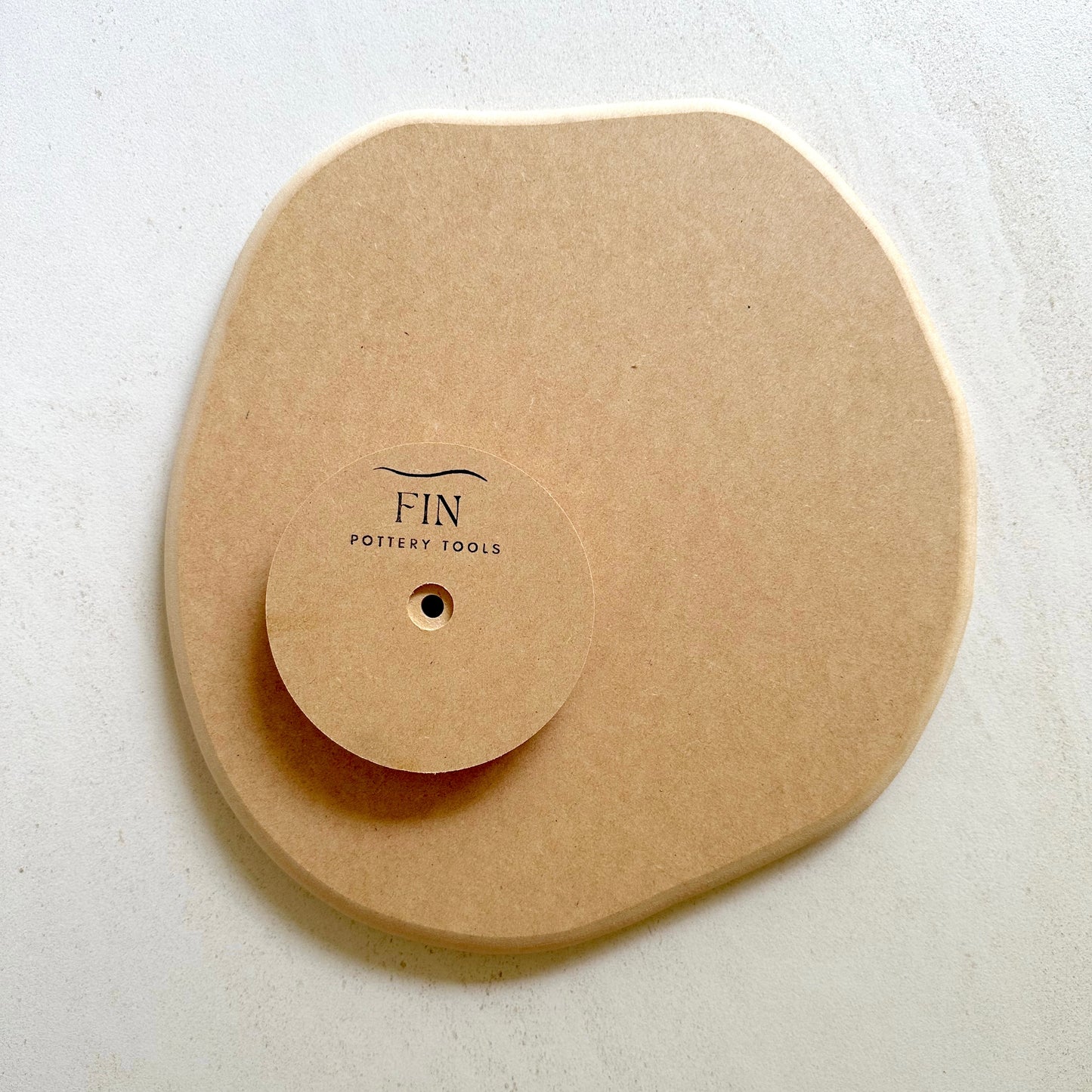 Irregular round pottery form/drape mould with soft roundover edge.