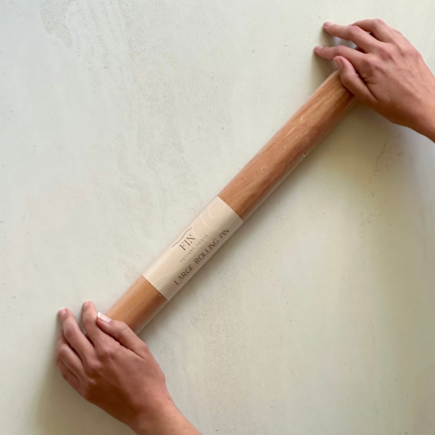 Large timber rolling pin for rolling large, even slabs of clay. Measures 50cm long and 4.3cm in diameter.