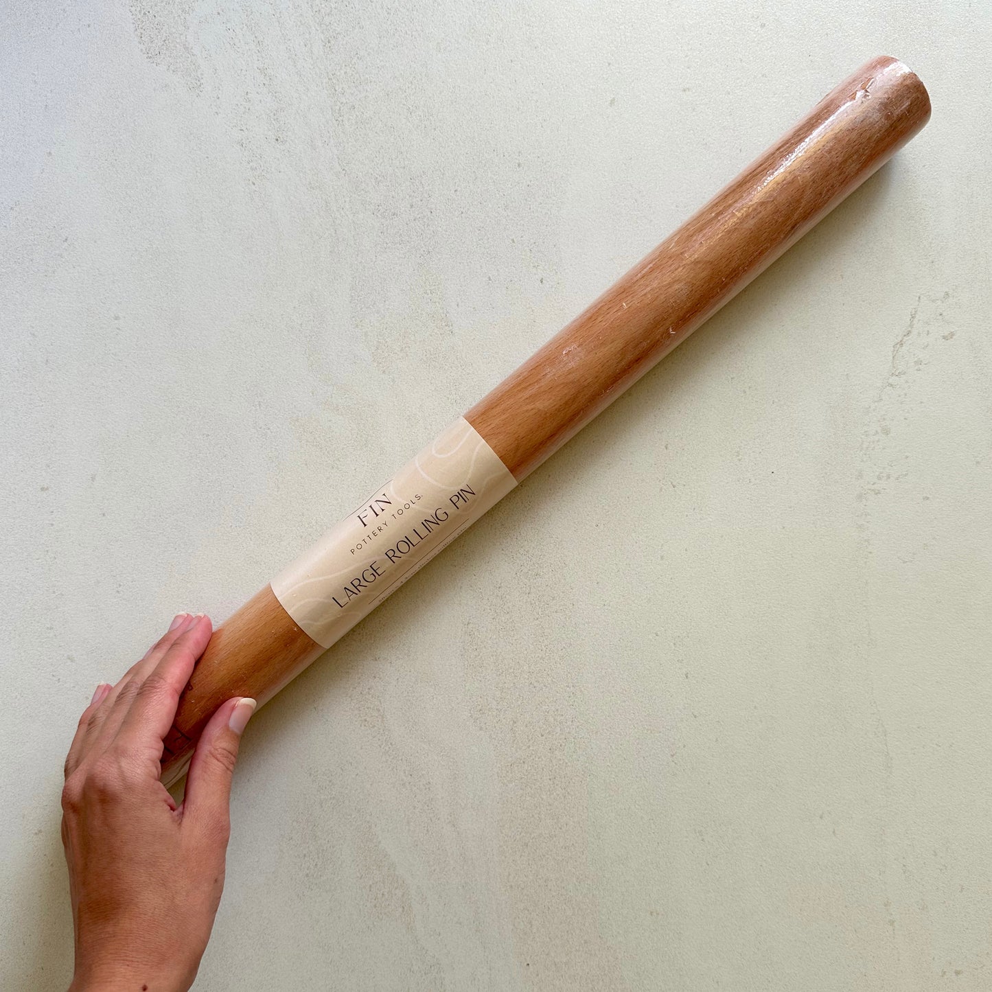 Large timber rolling pin for rolling large, even slabs of clay. Measures 50cm long and 4.3cm in diameter.