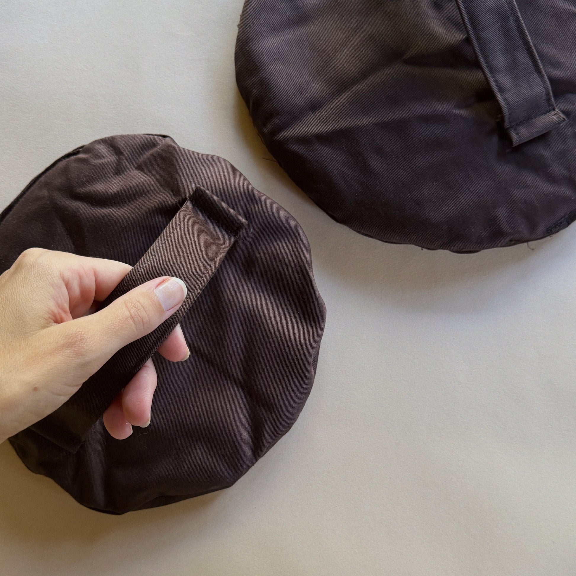 Two brown DIY sandbags to help plates dry flat
