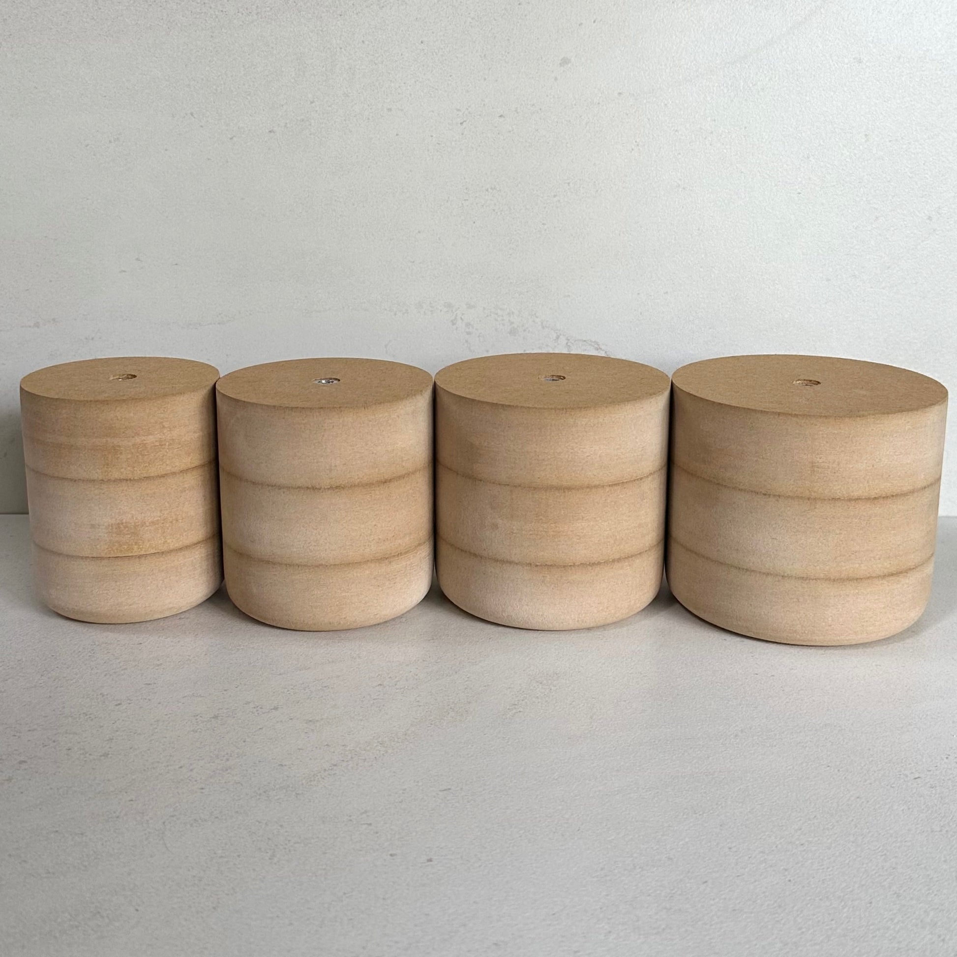 Four Fin Pottery Tools MDF mug moulds lined up on a light surface