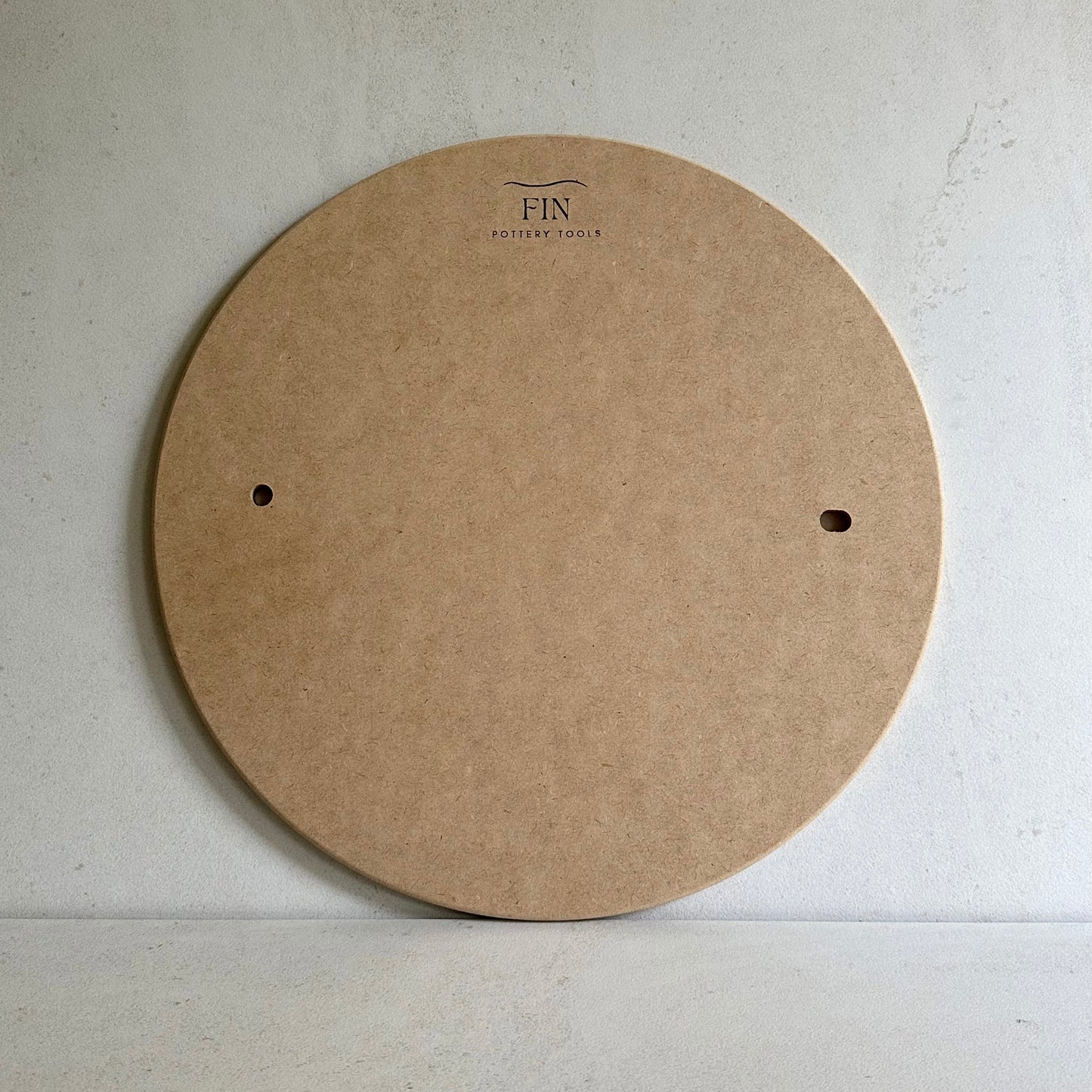 One MDF pottery bats with pin holes. compatible with Venco or Shimpo wheels, placed on a flat surface.
